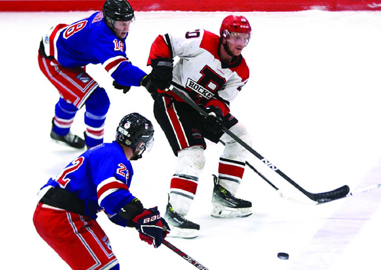 Monty Driver and Chad Hebert with the Moosomin Rangers and Kenton Miller with the Redvers Rockets during Game 4 in Moosomin.